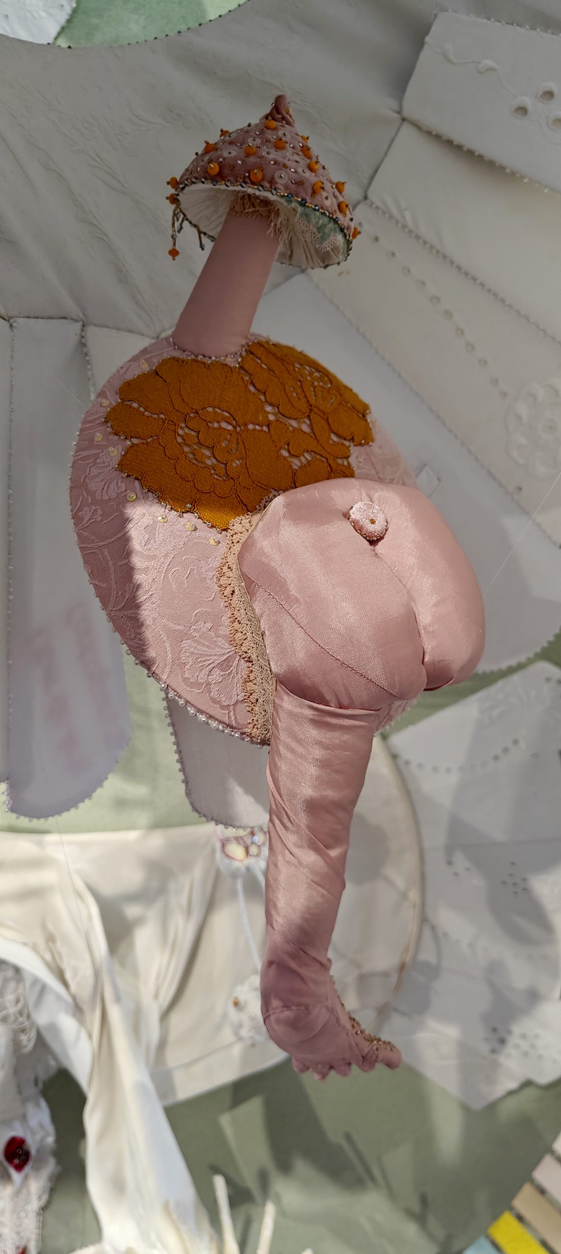 Pink baby body is sewn from a silk fabric. It has a velvet mushroom as a head.