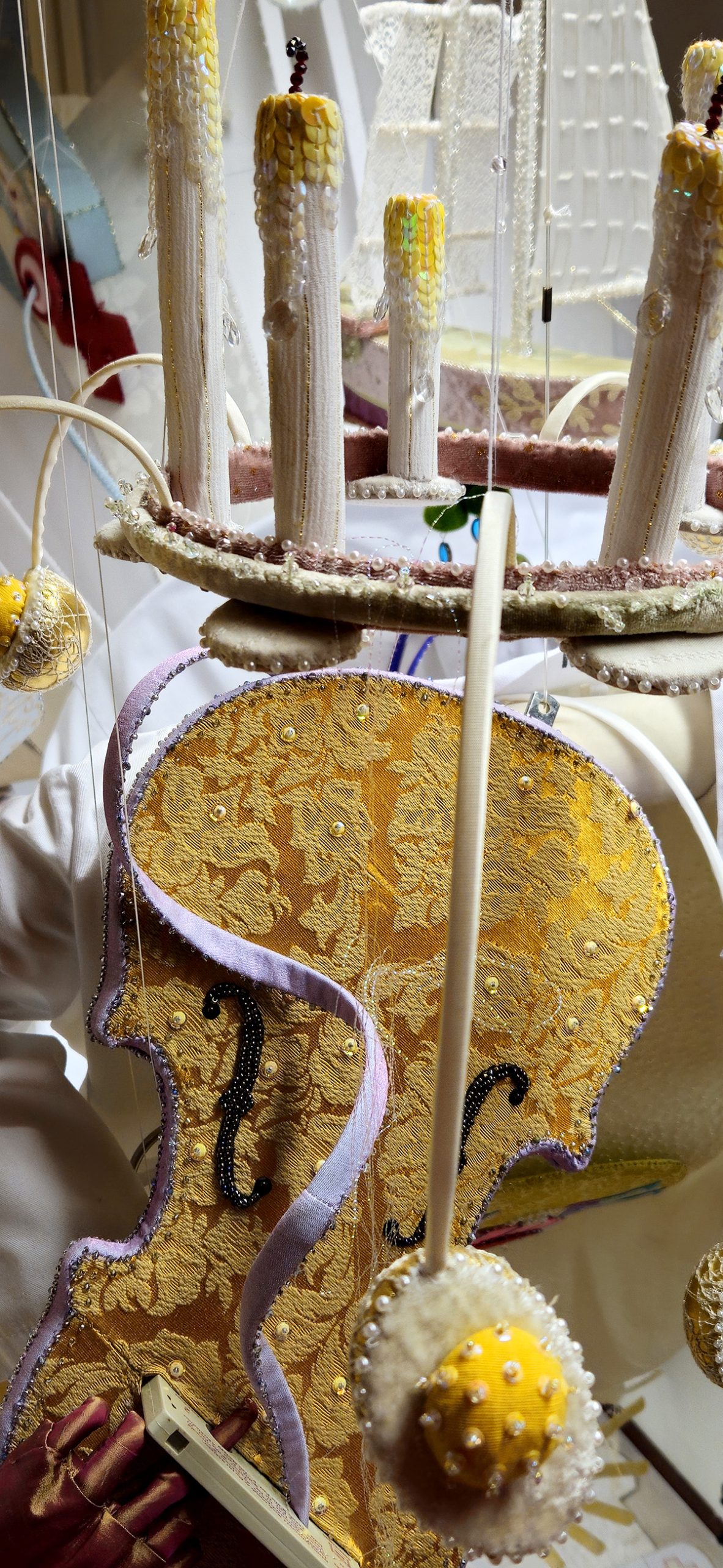 The crown of Saint Lucia, its candles unlit. From the crown protrude silk-covered branches, each tipped with a half of a boiled egg.